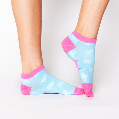 woman wears blue sock with pink trim and white tennis court pattern