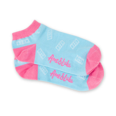 three pack of lawn tennis socks. Blue sock with pink trim, hot pink sock with green trim and yellow sock with red trim. All socks have white tennis court repeating pattern on them