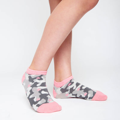 girl wearing pair of grey camo kids socks with light pink heel and toes, and pink stars stitched on to socks