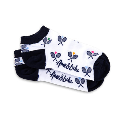 a pair of white socks with navy heels and toes, and navy crossed racquets and rainbow hearts pattern on socks