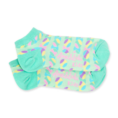 pair of light green kids socks with pastel rainbow tennis balls stitched around socks