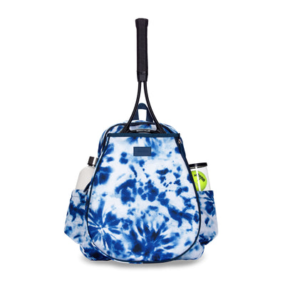 Front view of navy and white tie dye game on tennis backpack. Backpack has racquet in front pocket and water bottle and tennis balls in side pockets.