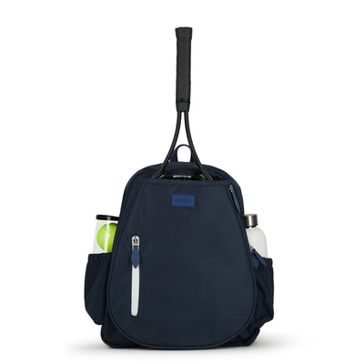 Front view of navy game time tennis backpack with white zipper on the front pocket. There is a tennis racquet in the front pocket and water bottle and tennis balls in the side pockets.
