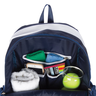 Inside view of navy and white striped tennis backpack showing tennis balls, phone, granola bar and a towel inside the backpack.