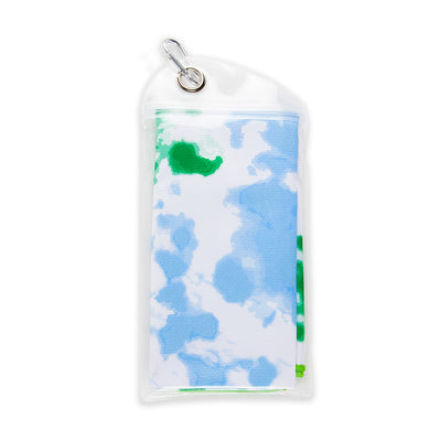 folded rectangular towel printed with green and blue tie dye pattern inside small carrying pouch