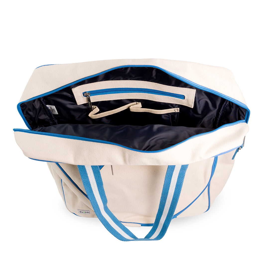 Inside view of canvas tennis tote with navy interior and pockets inside.