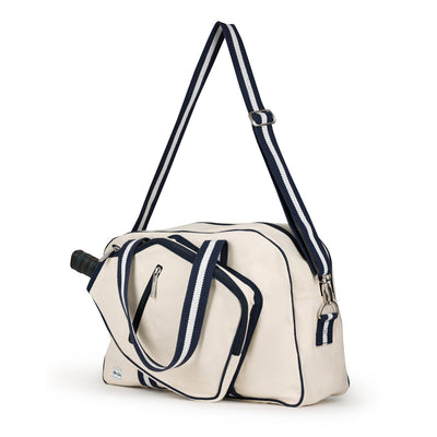 side view of natural colored canvas pickleball bag with navy cotton webbing adjustable shoulder strap