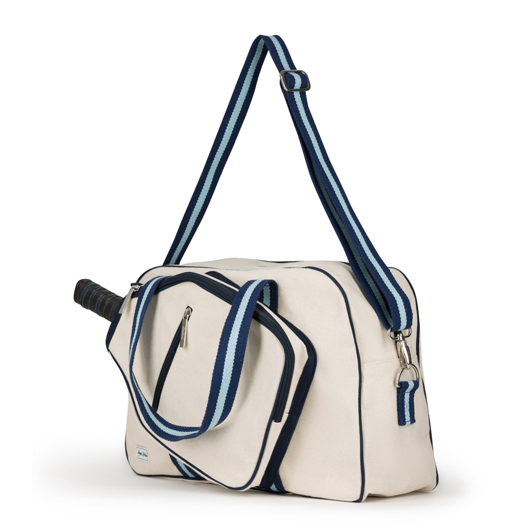 side view of natural colored canvas pickleball bag with light blue and navy cotton webbing straps