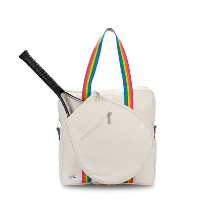 Front view of canvas hamptons tennis tour bag. Canvas tote has front pocket for tennis racquet and rainbow striped handles
