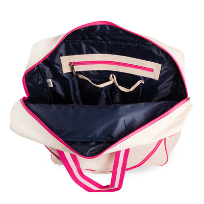 Inside view of large canvas tennis tote with front pocket for tennis racquet. Tote has hot pink trim and handles.