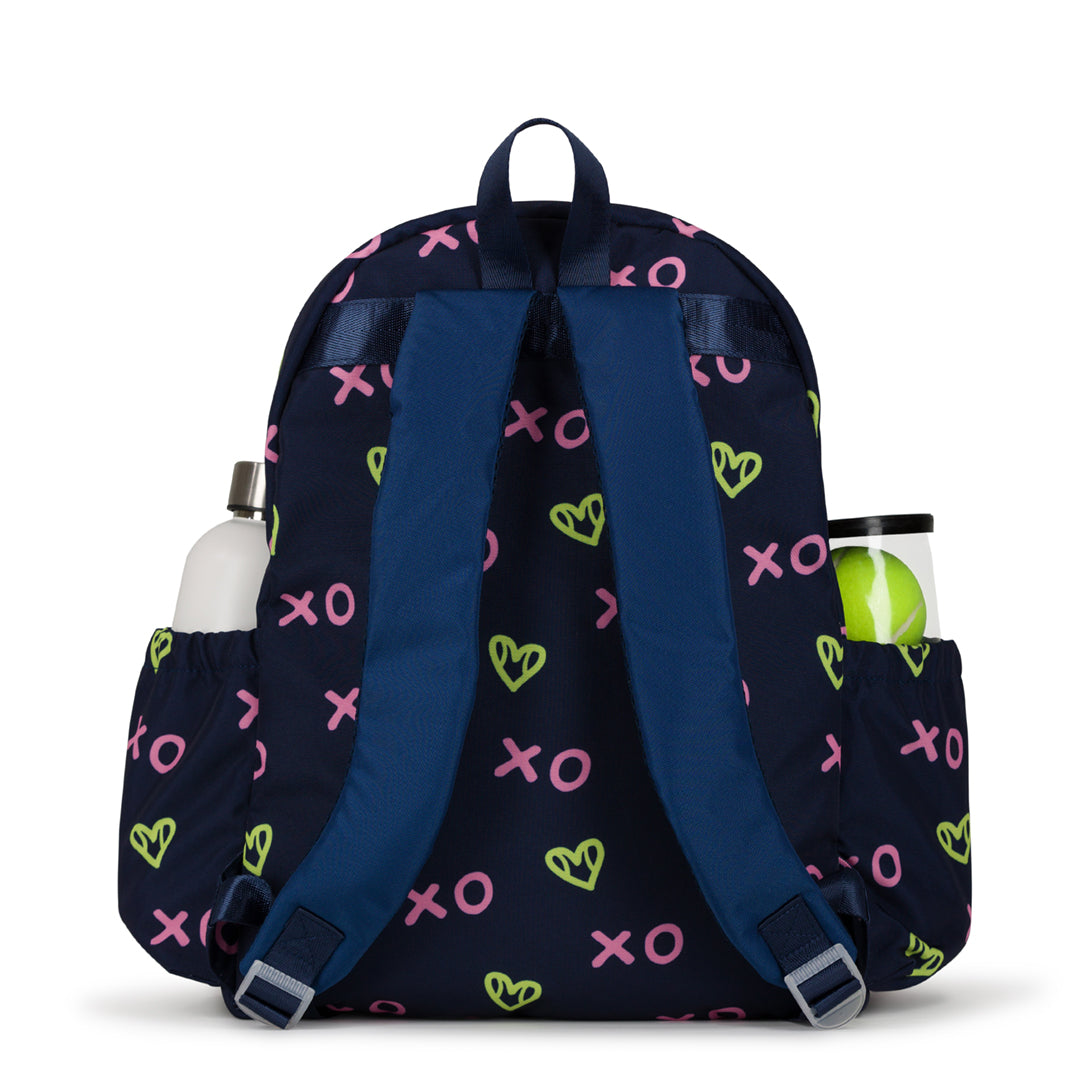 Back view of navy kids tennis backpack with repeating green heart shaped tennis balls and pink x and o.