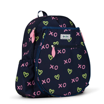 Side view of navy kids tennis backpack with repeating green heart shaped tennis balls and pink x and o.