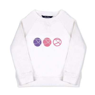 flay laying white kids sweatshirt with pink purple and white smiling tennis balls embroidered across the front