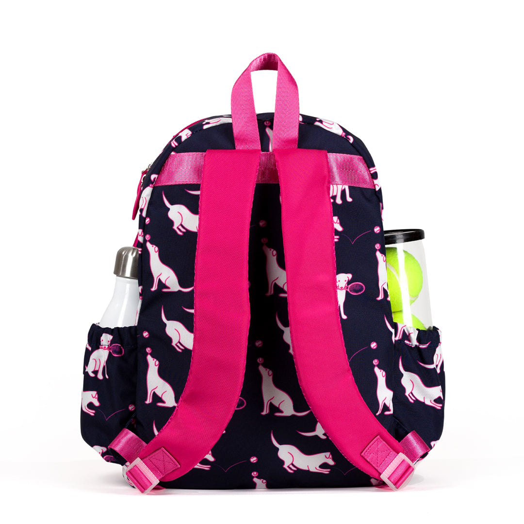 back view of navy kids tennis backpack with hot pink trim and pattern of white puppies holding tennis racquets and tennis balls