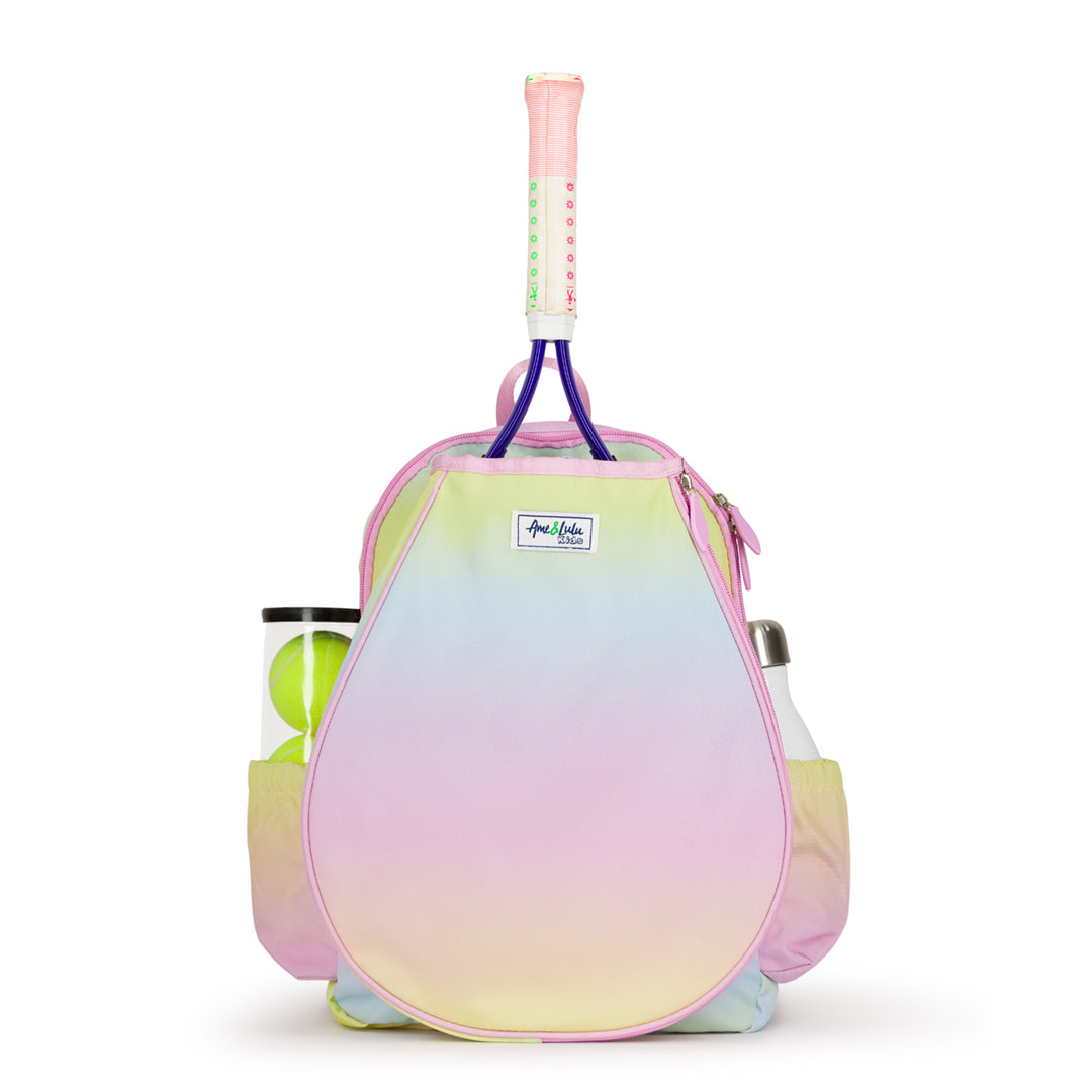 Front view of kids tennis backpack with rainbow ombre color. Backpack has water bottle and tennis balls in side pockets.
