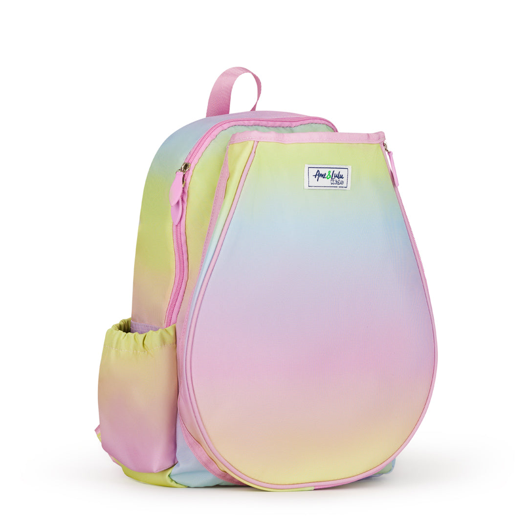 Side view of kids tennis backpack with rainbow ombre color. Backpack has water bottle and tennis balls in side pockets.
