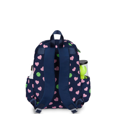 Back view of navy kids tennis backpack with pink hearts and green tennis ball pattern.