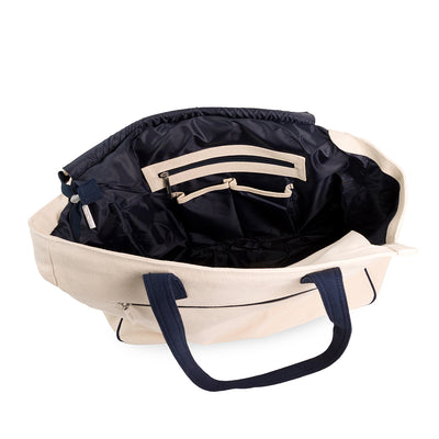 Inside view of love all court bag. Showing navy interior and the pockets inside the bag.