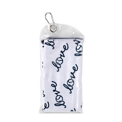 folded rectangular white towel with repeating pattern of the word love in a cursive font in a small carrying pouch