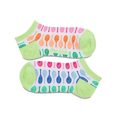 Pair of white socks with lime green heels and toes. Rainbow racquets are printed around the socks.