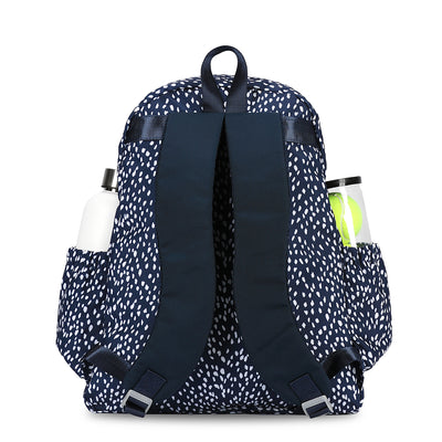 Back view of navy and white spotted antelope pattern tennis backpack. Backpack has water bottle and tennis balls in side pockets.