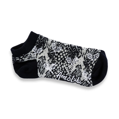 a grey sock with navy and grey snakeskin and white tennis racquets pattern