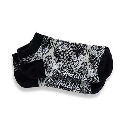 a pair of grey socks with navy and grey snakeskin and white tennis racquets pattern