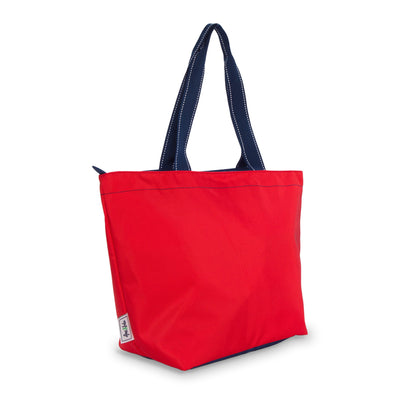 side view of red nylon tote bag with navy straps