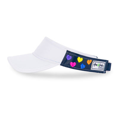 Side view of navy kids visor with rainbow heart shaped tennis balls printed on sides