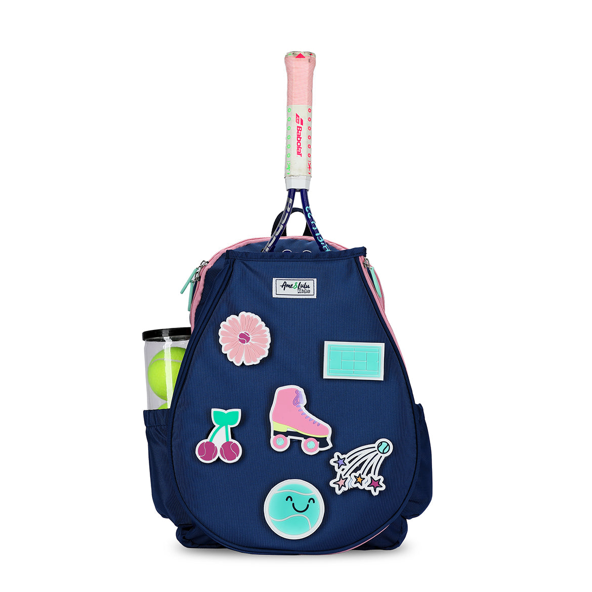 Front view of navy kids tennis backpack with removeable patches. Patches shown are pink flower, cherries, roller skate, tennis court, smiling tennis ball and shooting star tennis ball.