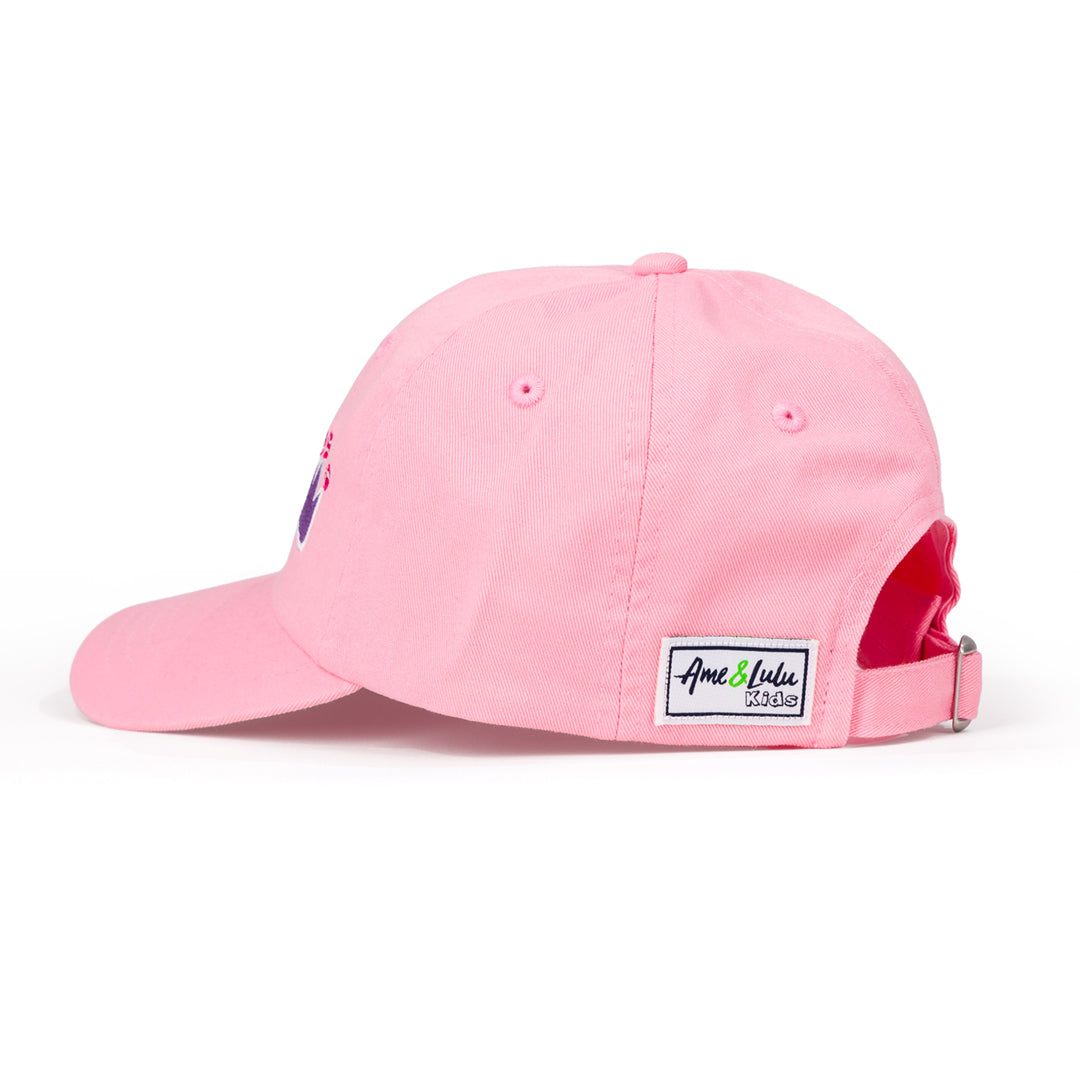 Side view of light pink kids baseball hat with purple crowns and tennis balls embroidered on front.
