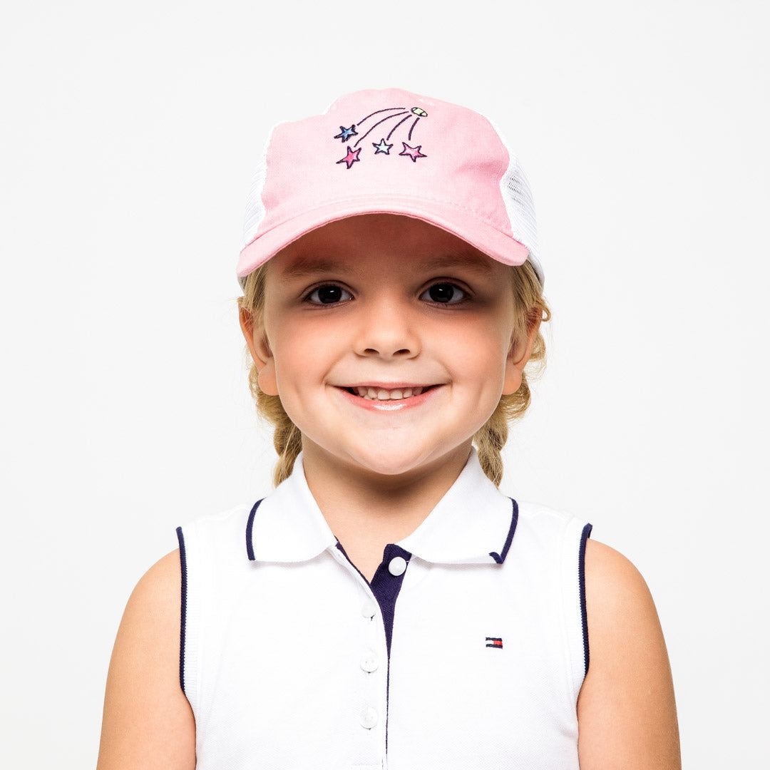Little girl wearing pink and white kids trucker hat with shooting stars embroidered on the front
