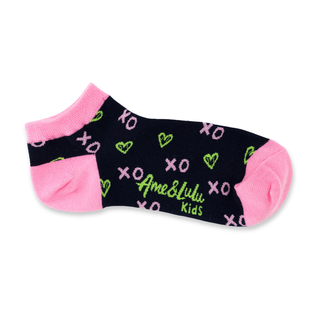 pair of navy kids socks with pink heel and toes, and green heart shaped tennis balls