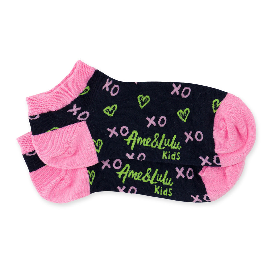 pair of navy kids socks with pink heel and toes, and green heart shaped tennis balls