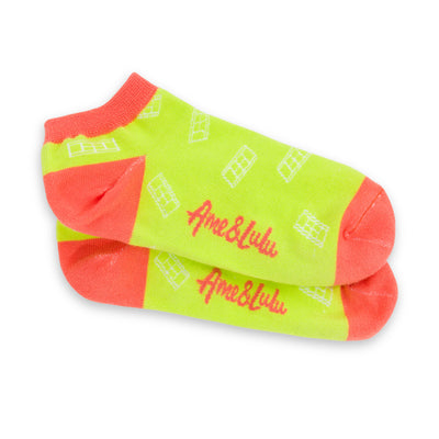 three pack of lawn tennis socks. Blue sock with pink trim, hot pink sock with green trim and yellow sock with red trim. All socks have white tennis court repeating pattern on them