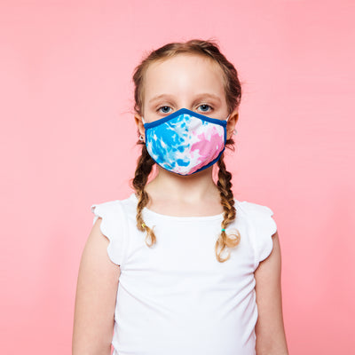 girl wearing blue and pink tie dye kids face mask