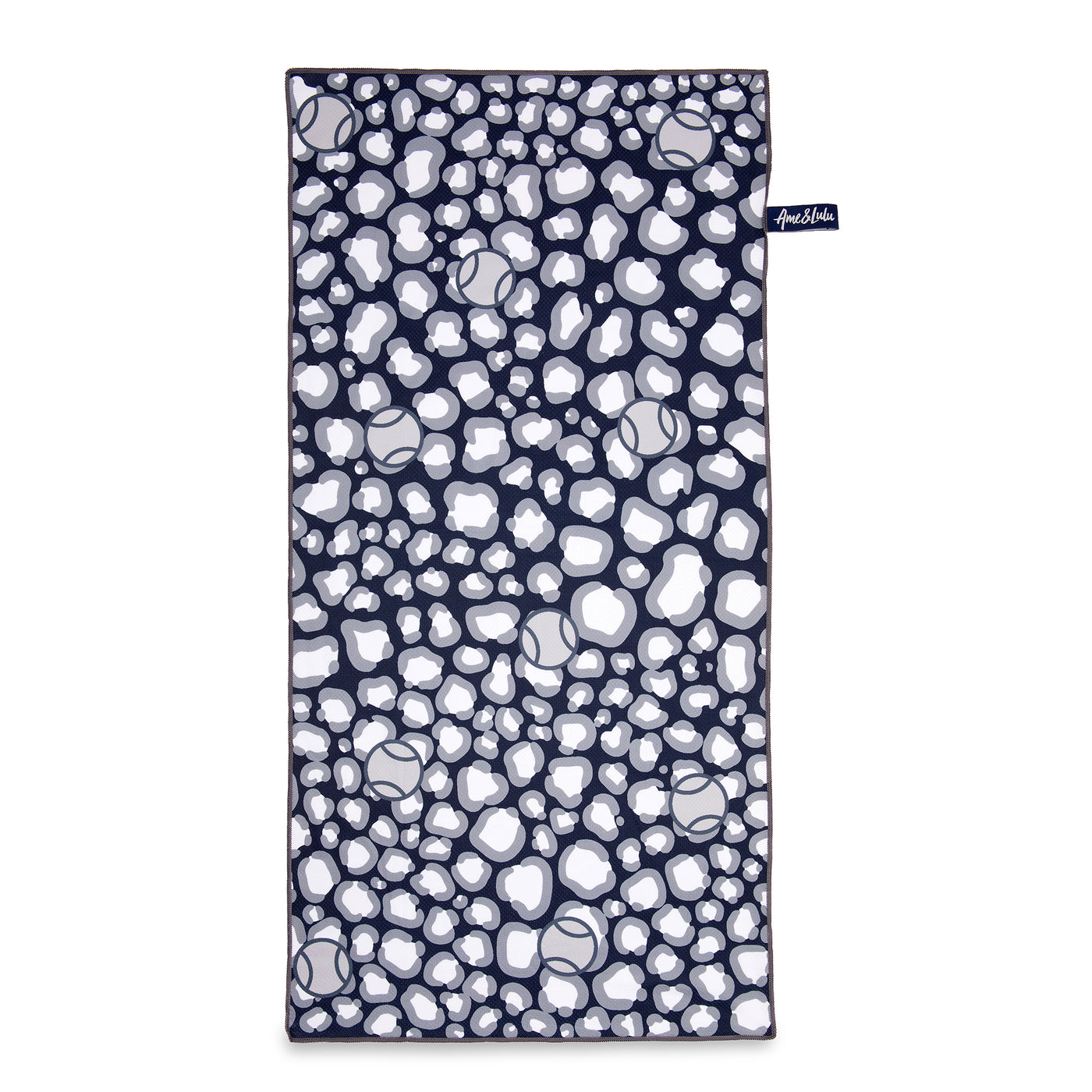 Rectangular towel with navy and grey repeating leopard pattern with tennis balls icons printed over the leopard.