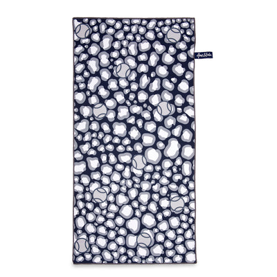Rectangular towel with navy and grey repeating leopard pattern with tennis balls icons printed over the leopard.