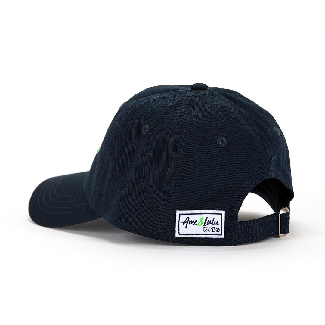 Back view of navy kids baseball hat with white peace sign, pink heart and green tennis ball embroidered on front.